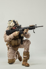 Soldier in camouflage holding rifle