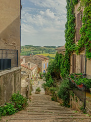 Fototapeta premium Cordes-Sur-Ciel, Midi Pyrenees, France - July 19, 2017: Typical narrow street of the village Cordes-sur-Ciel in Occitania