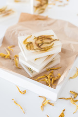 White handmade soap bars with yellow sunflower petals