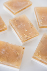 White and beige handmade soap bars with oat flakes