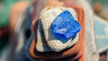 Top view of stone pyramid with blue sea polished glass on top