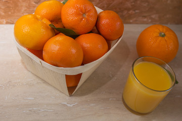 glass  of fresh orange juice with fresh fruits