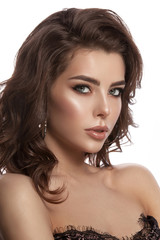 Fototapeta premium Beauty portrait of a young girl with natural make-up and natural lip color. Hairstyle curls, chestnut hair color. White isolated background.