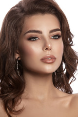 Obraz premium Beauty portrait of a young girl with natural make-up and natural lip color. Hairstyle curls, chestnut hair color. White isolated background.