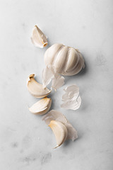 Garlic cloves viewed from above isolated on a marble background. Kitchen ingredients used for food...