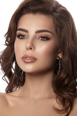 Obraz premium Beauty portrait of a young girl with natural make-up and natural lip color. Hairstyle curls, chestnut hair color. White isolated background.