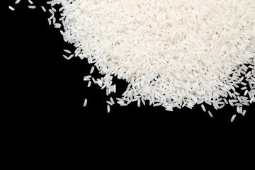 Uncooked white rice isolated on black background. food concept