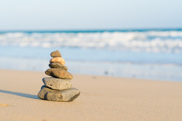 Zen stone little pile on sea beach