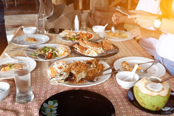 Shrimp, fried snapper fish with garlic, fried oyster shell Black Pepper and antipasto appetizer sitting on table in fine dining restaurant.