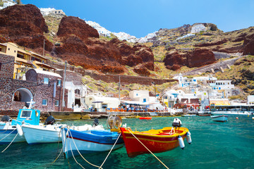 Fototapeta na wymiar Old port of Oia village at Santorini island in aegean sea, Greece.