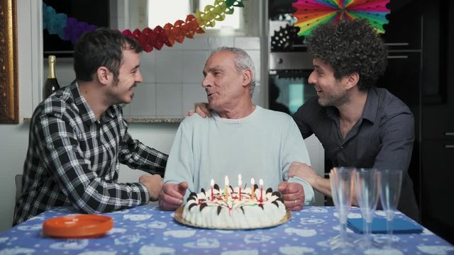 Two affectionate sons celebrate their birthday with their old father
