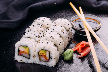 Sushi roll served with wasabi and ginger