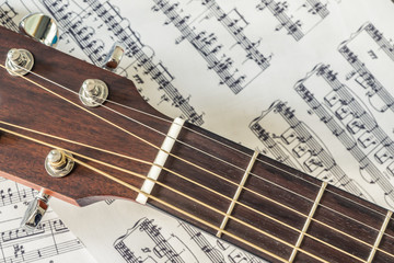 Close-up picture of acoustic guitar and music note