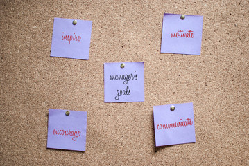 Multiple notes (stickers) with handwritten words on a cork board. Manager's responsibilities