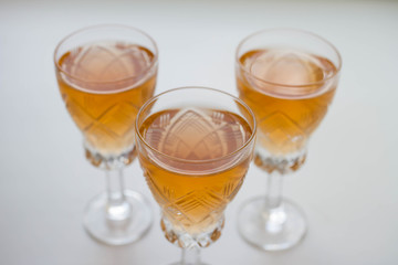 three glass of white or pink wine standing on the table. selective focus