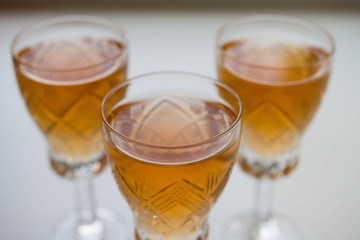 three glass of white or pink wine standing on the table. selective focus