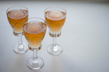 three glass of white or pink wine standing on the table. selective focus