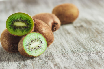 Green kiwis on the wooden background