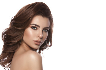 Fototapeta premium Beauty portrait of a young girl with natural make-up and natural lip color. Hairstyle curls, chestnut hair color. White isolated background.