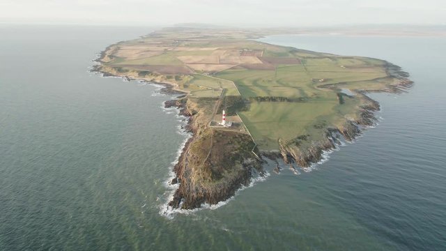 Aerial drone shot of Tarbat Ness lighthouse in Scotland during a sunset