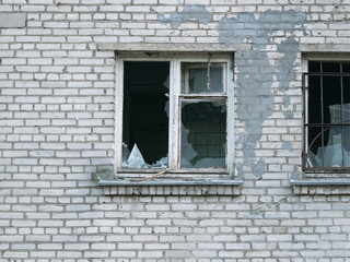 Abandoned brick building with broken window
