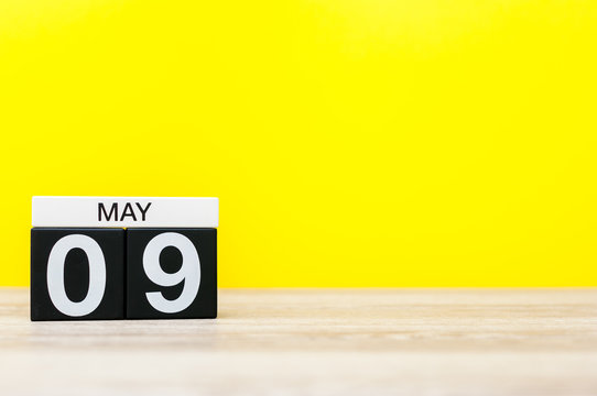 May 9th. Day 9 of may month, calendar on yellow background. Spring time, empty space for text