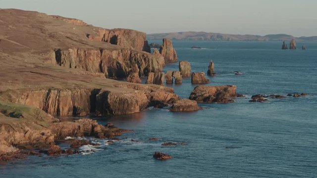Aerial drone shot of cliffs in Braewick, Shetland during a sunset