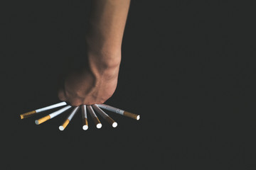 Man's hand crushing cigarettes. STOP Smoking. World no tobacco day concept.