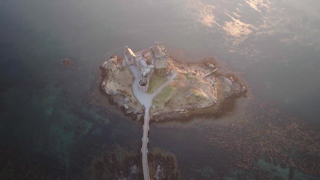 Top down aerial drone shot of Eilean Donan castle in the Scottish Highlands 