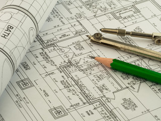 architectural background with plan, blueprint roll, pencil and drawing compass. Technical drawings