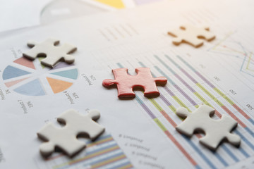 close up of puzzle pieces on graph chart, business and connection concept