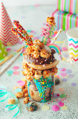 Naklejka premium Chocolate freak shake with donut on the party table