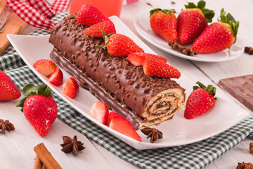 Chocolate roll with strawberries. 