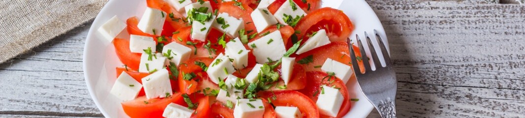 Banner of Fresh salad with tomato, mozzarella and herbs.