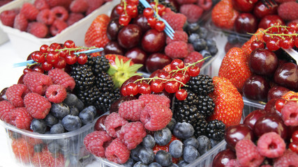 Fresh berries in plastic containers on a market