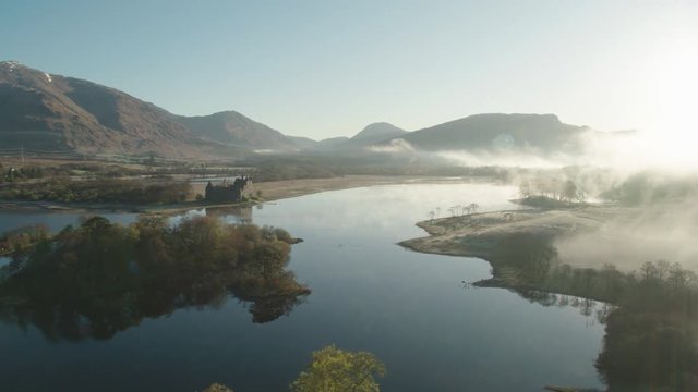 Low hanging mist over tree's near Kilchurn castle, Scotland