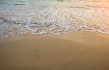Waves of the seashore reach the beaches by the sea and footprint