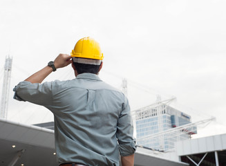 engineer,engineer man,engineer hat,Engineer is looking at the construction,smart engineer on day light background