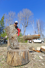 A man splitting firewood with an ax.