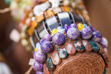 Gemstone bracelets and necklaces in a row. Jewelry made of heliotrope stone and sugilite blue stone. Healing, powerful crystal energy. Esoteric and colorful background