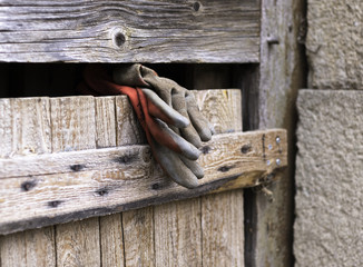Work gloves stuck in a wooden construction