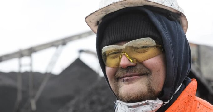 Coal miner, portrait of a young miner or stoker in the workplace.