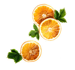 Dried orange round slices with green leaves on an isolated white background.