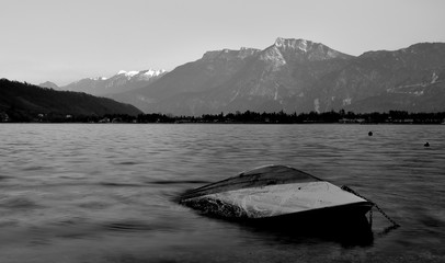 Underwater: boat in a lake, mountains in the background