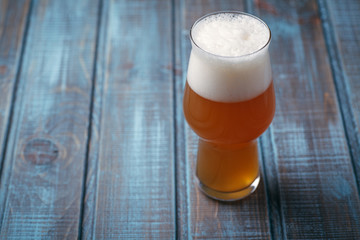 Pale ale on blue wood