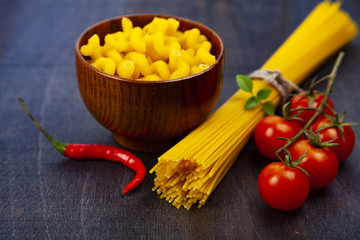 Different pasta on a dark wooden background