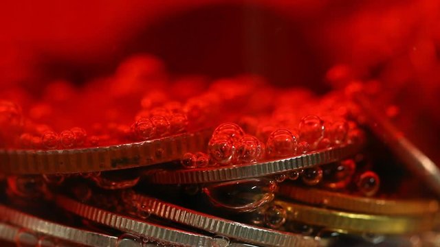 Coins  with red soda bubble in glass