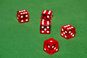 Dices on a green velvet table.