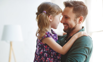 Father's day. Happy family daughter hugs his dad