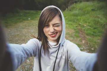 Close-up of young beautiful woman taking selfie